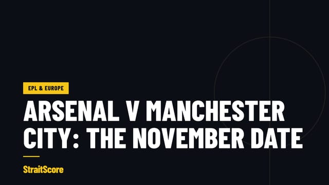 An Arsenal player and a Manchester City player challenge for a high ball under floodlights.